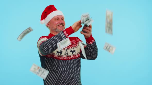 Rich Man Winner in Christmas Red Sweater and Hat Showing Wasting Throwing Money Around Shopping