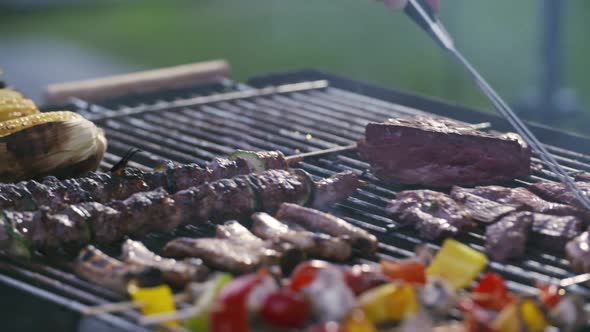 Peppers Green Chilies Corn Onion Hamburgers Brats and Kabobs Arranged on a Bbq Grill