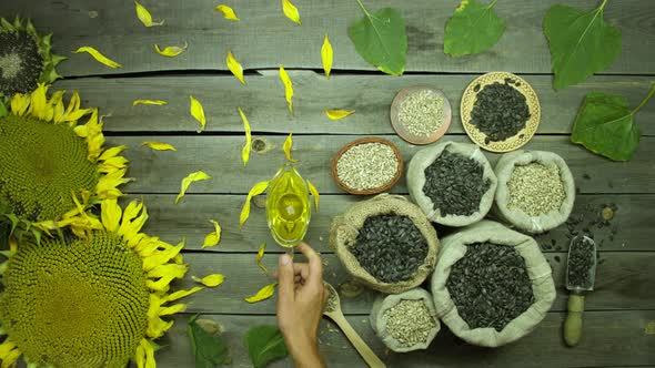 Sunflower oil and seeds on an old wooden table. Top view.