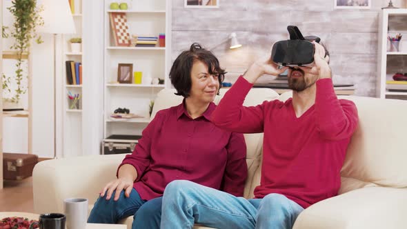 Nephew Showing His Grandmother How To Use VR Goggles