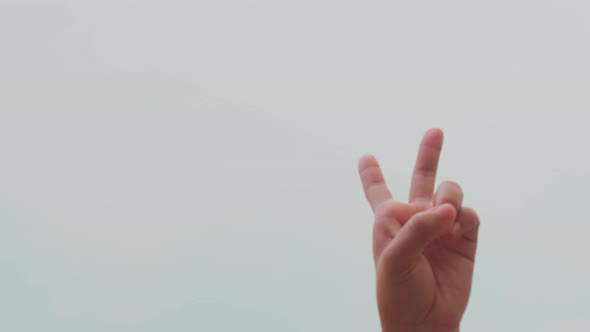 New Year 2022 in sign language over blue sky background.