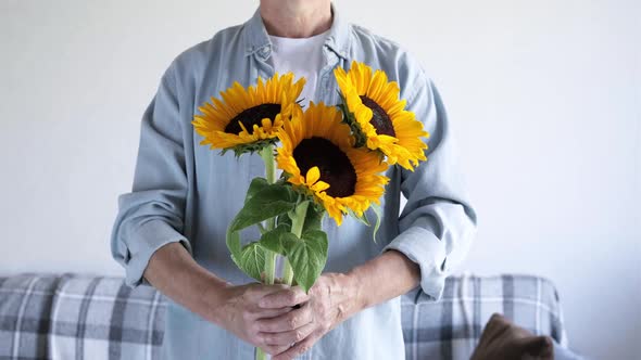 Man's Hand Gives a Bouquet of Flowers