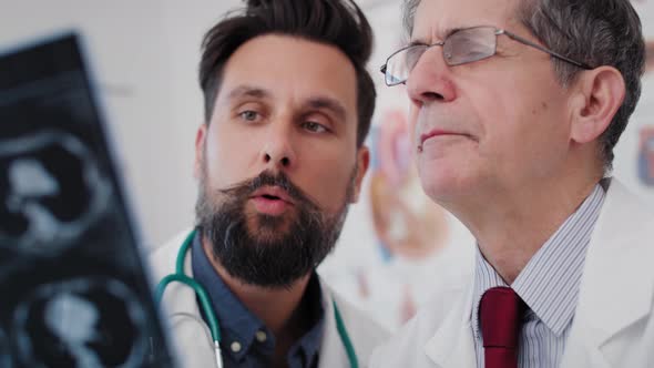 Handheld view of doctors examining the results of the radiology. Shot with RED helium camera 