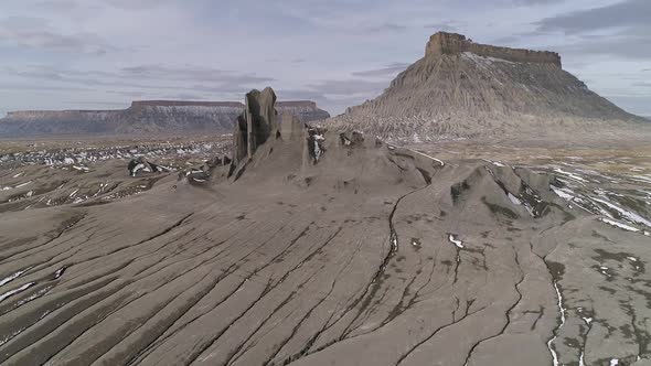 Flying low through eroded desert towards Factory Butte in Utah