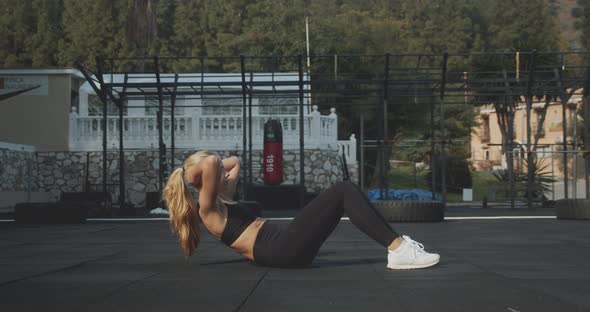 Athlete Performing SitUps In Outdoor Gym