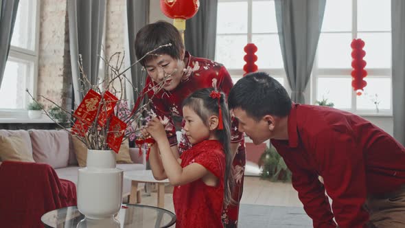 Happy Chinese Family Decorating for Lunar New Year