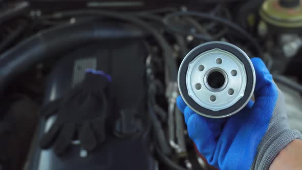 Oil Filter Replacement Car Engine Maintenance Mechanic Hands in Gloves Close-up