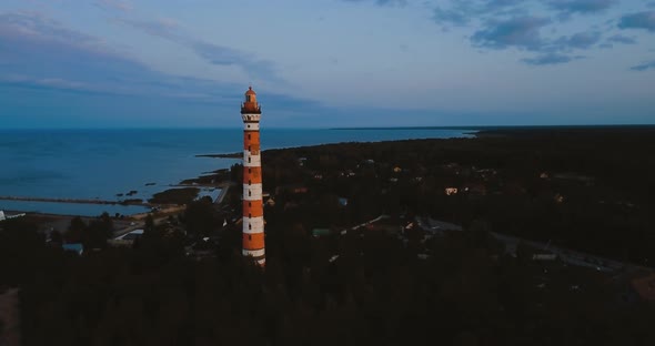 Old Active Lighthouse. Gloomy Sky and Cold Blue Atmosphere. Beach, North Misty Sea in Vintage