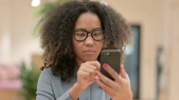 Portrait of African Businesswoman Scrolling on Smartphone