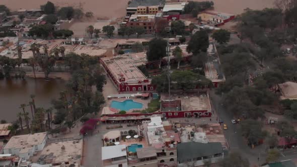 Smooth Drone Aerial Shot of Huacachina Oasis in Peru Oasis in Deserted Sands