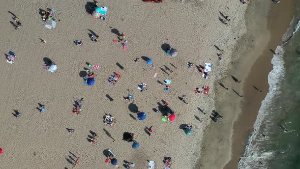 Crowded Beach And The Sea - aerial top down