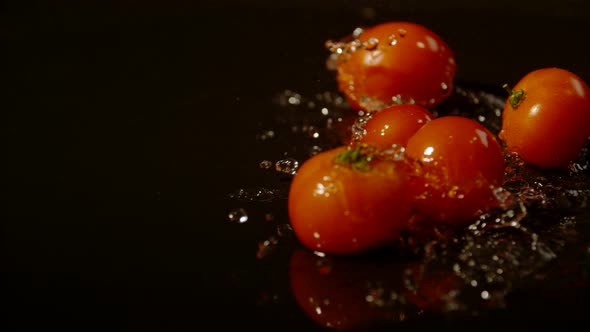Tomatoes falling and spinning on wet surface, Ultra Slow Motion
