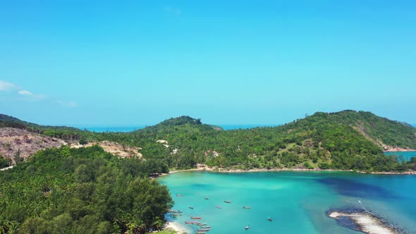 Aerial drone shot scenery of tropical sea view beach trip by blue water and white sandy background o