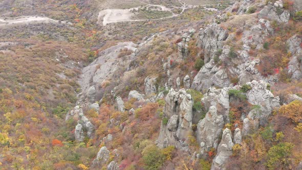 Aerial View Sharp High Cliffs Towering Over Mountains with Autumn Forest