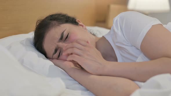 Young Indian Woman Crying while Sleeping in Bed