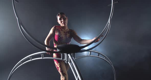 Pretty Woman in Red Costume is Spinning a Steel Hoop Gymnastics Show