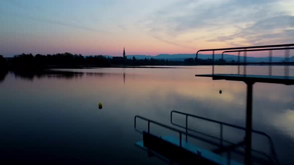 Sun rise by the lake passing the diving platform on the left