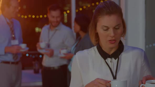 Businesspeople having coffee while interacting during break