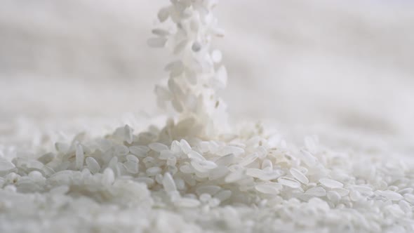 Throwing rice over pile of rice. Slow Motion.