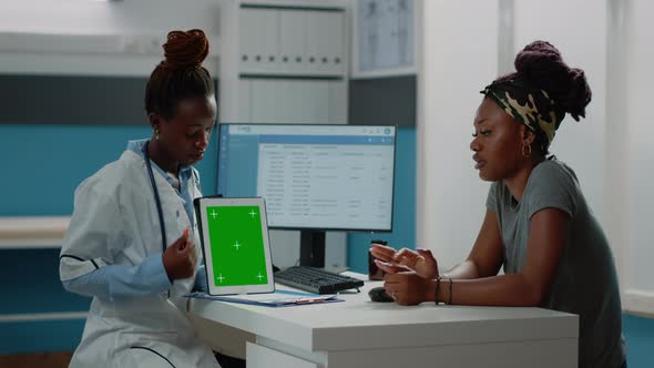 Medic Pointing at Tablet with Green Screen and Talking to Patient