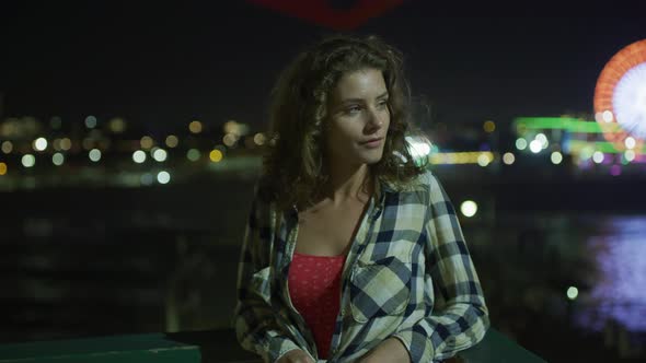 Night view of a girl on Santa Monica Pier alt