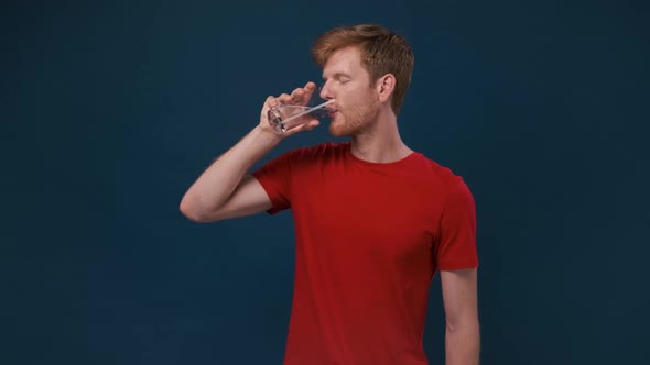 Young Man 20s Years Old Hold Water Isolated on Blue Pastel Wall Background Studio Portrait