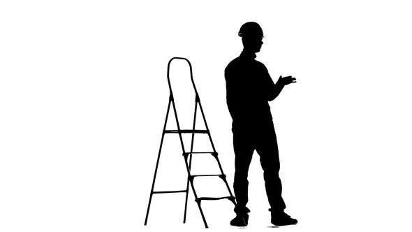 Brigadier in a Helmet Stands Near the Stepladder. Silhouette. White Background