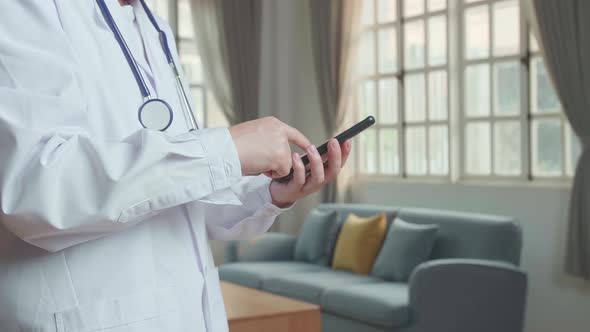 Man Doctor Using Mobile Phone At Home Office