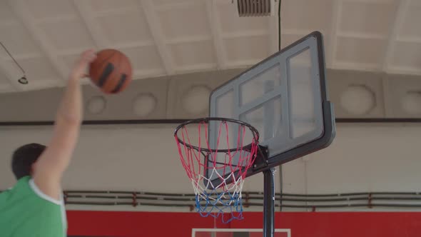 Basketball Player Flying Towards Rim for Slam Dunk