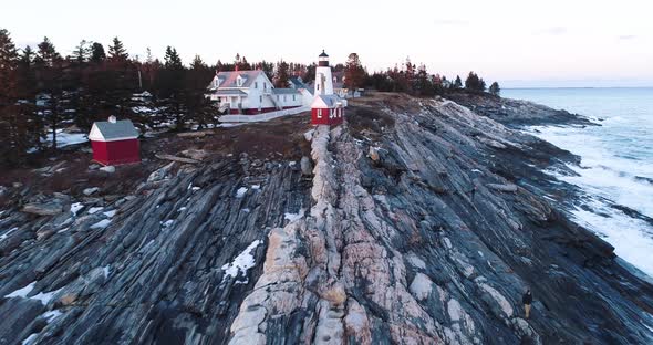 Aerial view from the edge of the bedrock inland highlighting the Grindel Point Light Islesboro Maine