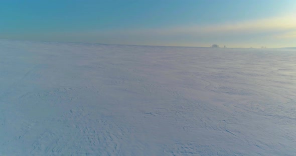 Aerial View of Cold Winter Landscape Arctic Field Trees Covered with Frost Snow Ice River and Sun