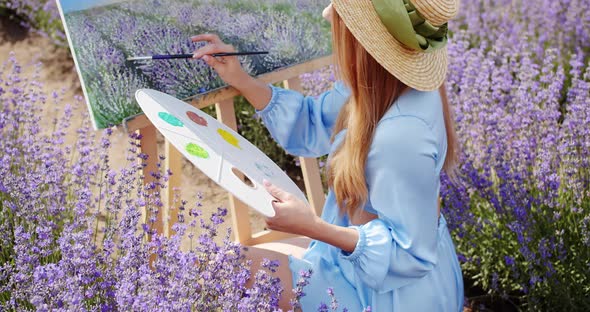 a Young Artist Paints a Picture in a Lavender Field