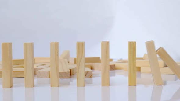 Domino Effect Row of Wooden Domino Falling Down on White Background