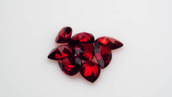 Natural Red Garnet Gemstone on the White Background on the Turning Table