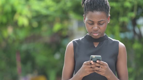 Young Beautiful African Businesswoman Using Phone Outdoors