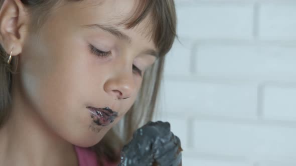 Portrait of a girl stained with ice cream.