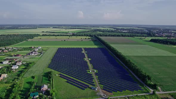 Aerial View of Solar Panels Stand in a Row in the Fields