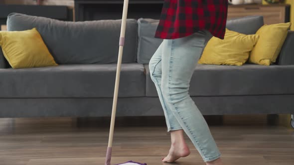 Young Woman Mopping the Floor and Dancing