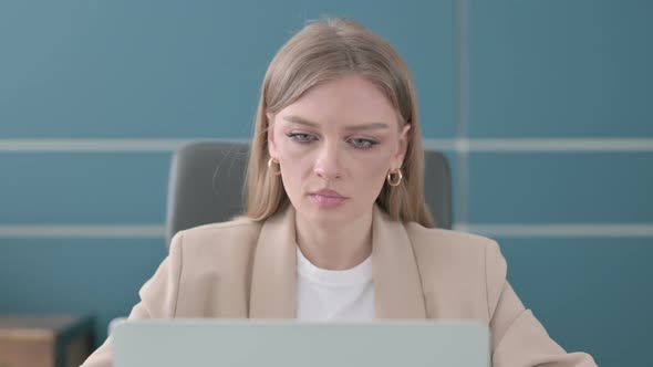 Close Up of Businesswoman Shaking Head As No Sign While Using Laptop in Office