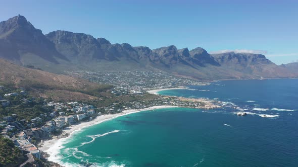 Aerial Moving Along the Shoreline of Camps Bay Cape Town South Africa with Twelve Apostles Mountains