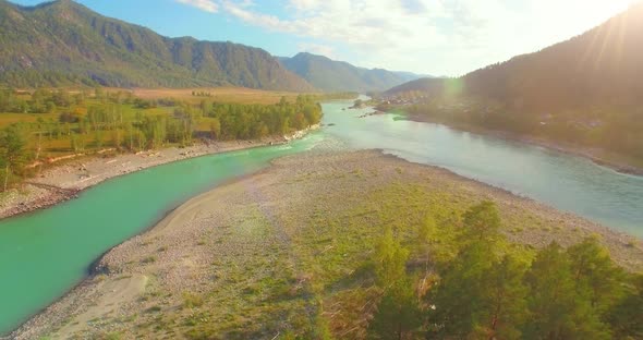 Low Altitude Flight Over Fresh Fast Mountain River with Rocks at Sunny Summer Morning