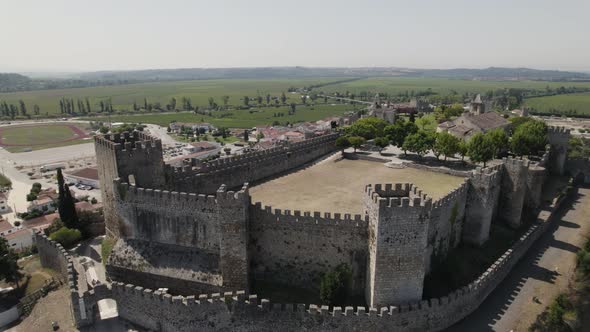 Fast parallax over famous Montemor-o-velho old fortress on hilltop, Portugal