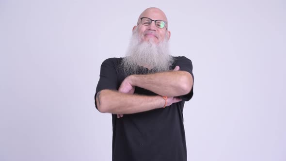 Happy Mature Bald Bearded Man Smiling with Arms Crossed