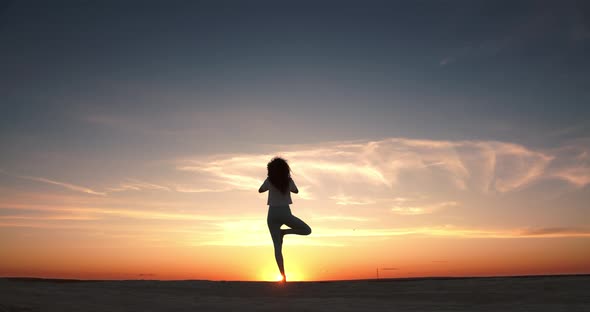 Girl Doing Yoga Asasana at Sunset