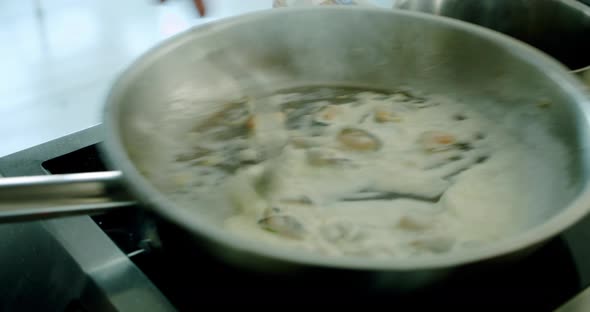 Mussels Fried on a Large Roasting Pan Boil and Steam Comes From Them