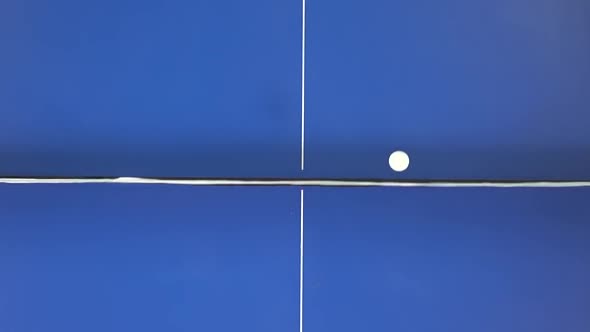 Ping Pong Concept. Two People Playing on a Blue Table. Close-up Top View. Slow Motion