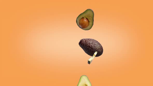 Avocado Halves and Slices That Fall on the Orange Background