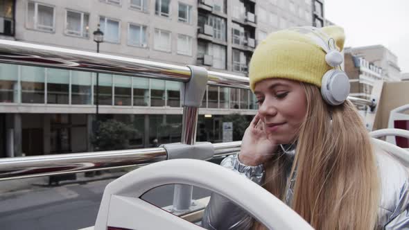 Blond Teenage Girl With Headphones On Bus