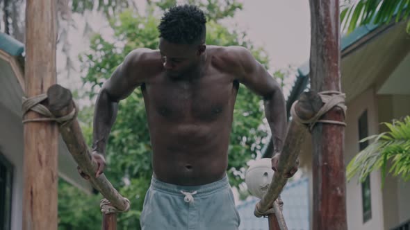 Young African American Fit Man Doing Dips on Parallel Bars