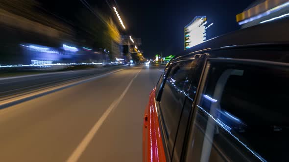 Drivelapse From Side of Car Moving on a Night Avenue in City Timelapse Hyperlapse